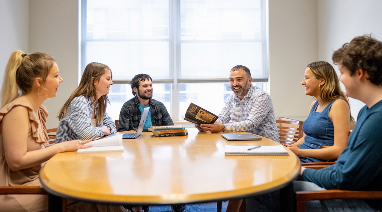 Professor and students around a table