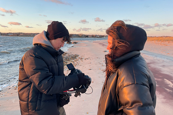 Two students filming the social justice documentary, "Seeds We Bury"