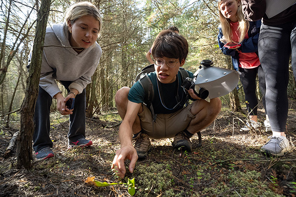Carter Young looks at species in the field.