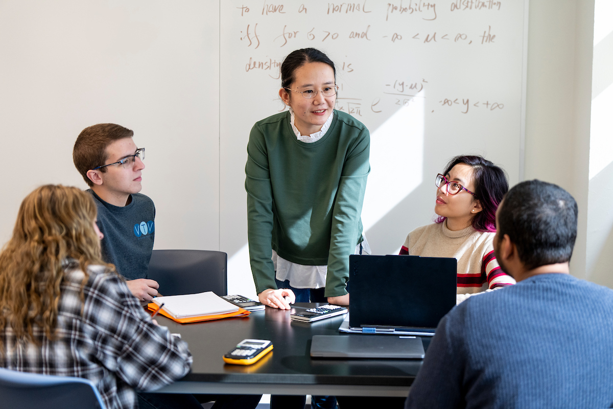applied statistics and data science graduate students taking notes in class