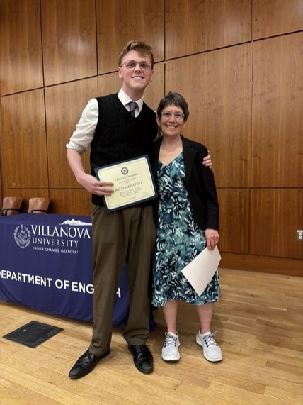  student and professor smiling