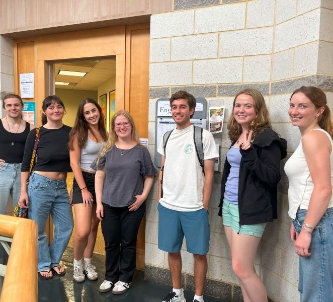 students in front of office