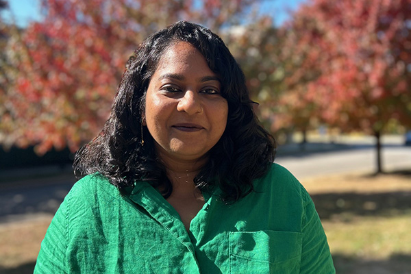 image of Anusha Hariharan smiling in front of trees