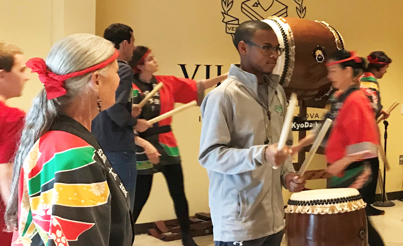 Student participating in a Taiko demonstration.