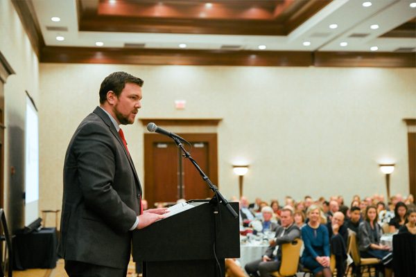 image of Robert speaking at podium