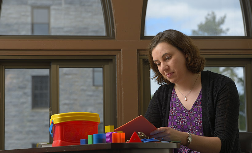 image of woman in front of large window reading