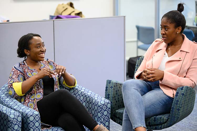 Two HR professionals sitting in an office common area