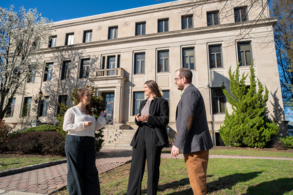Three Villanovans standing outside a public building