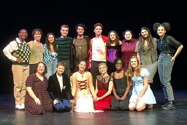 Cast standing on stage