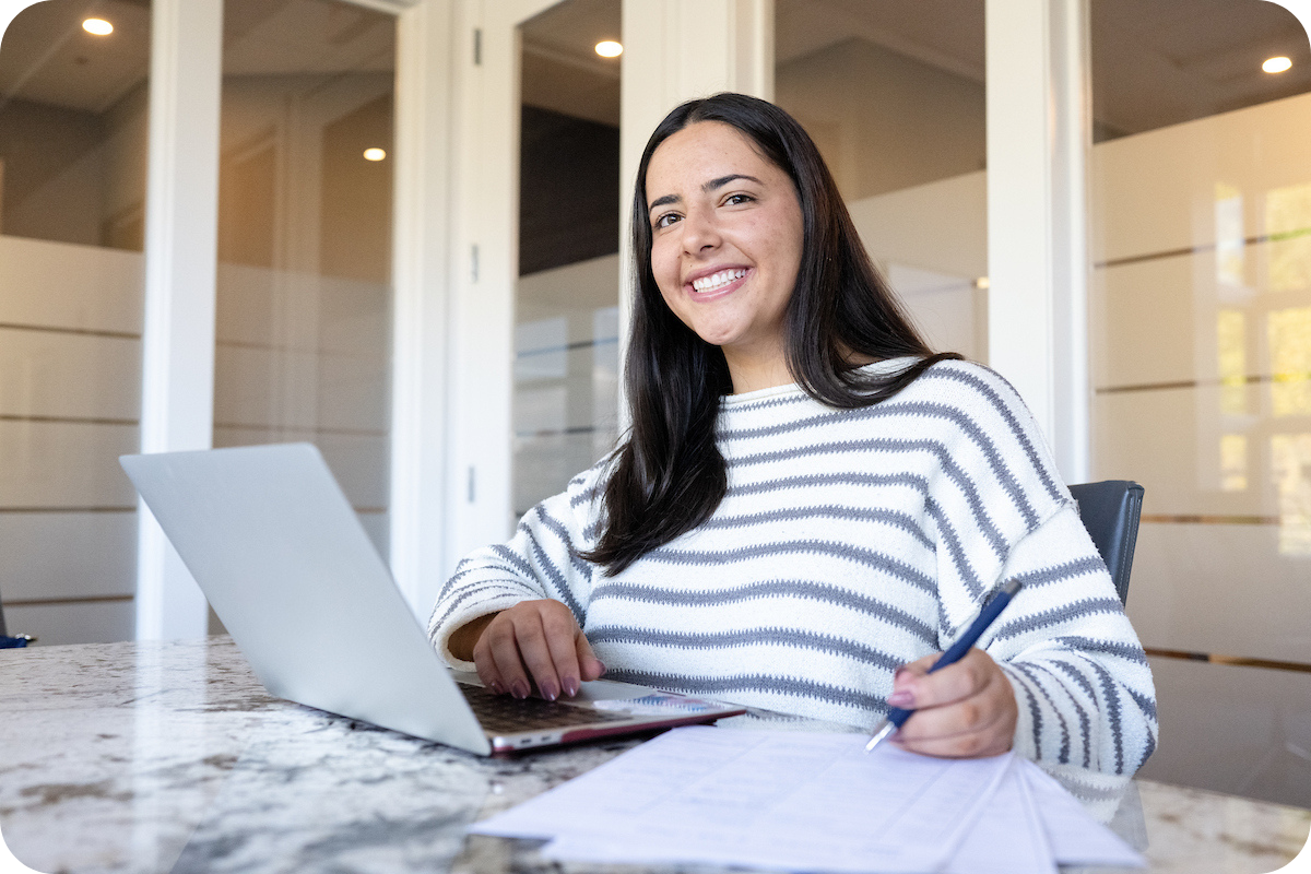 student smiling at desk