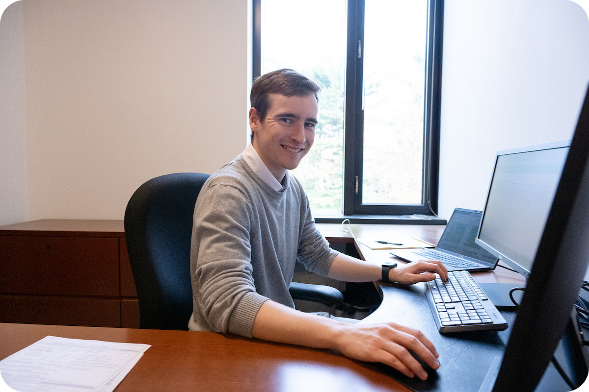 student smiling at desk