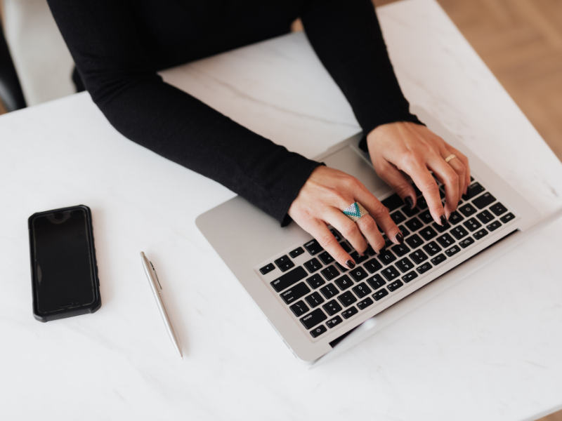 hands typing on a laptop