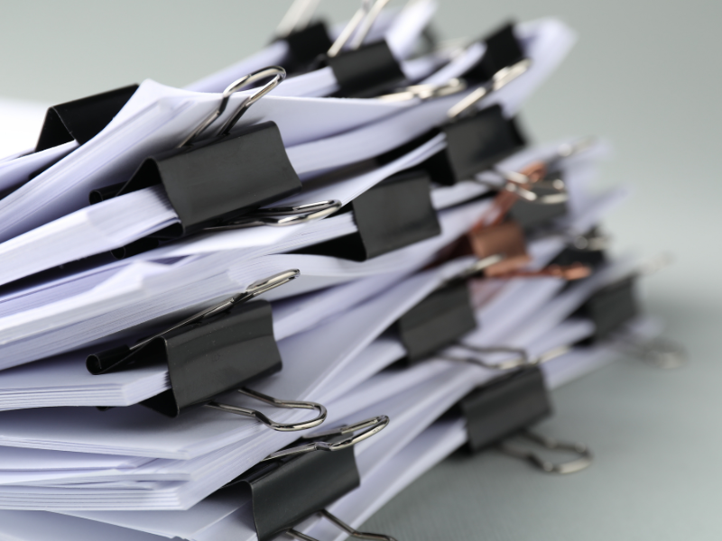 stack of papers held together by binder clips.