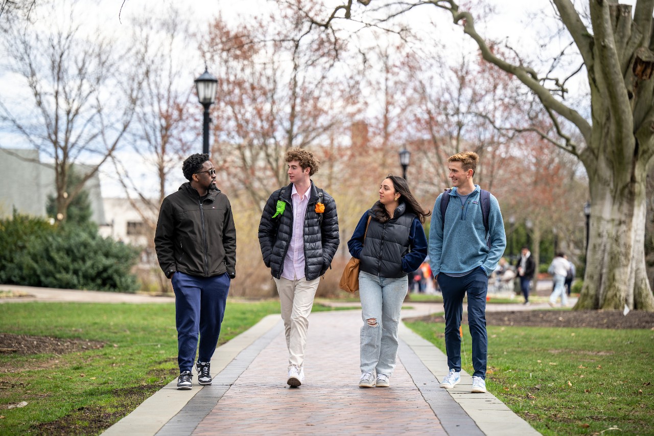 four students walking on campus