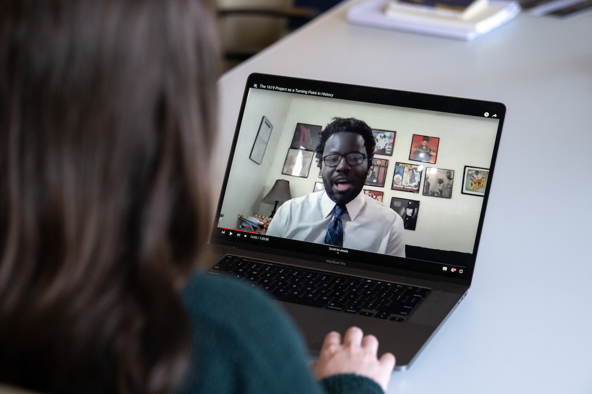 student watching a male faculty member teaching on her laptop