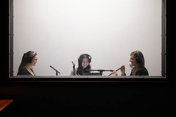 Students and faculty talking in a podcast both