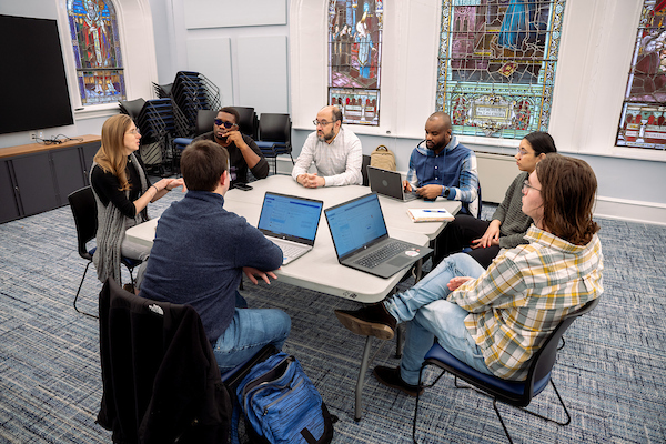 Students sitting at a table having a discussion