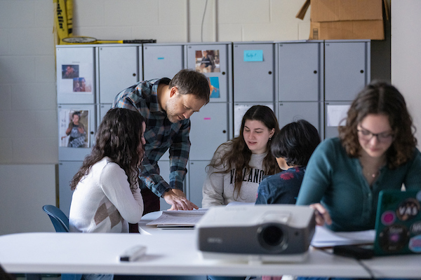 Male professor teaching a small group of students