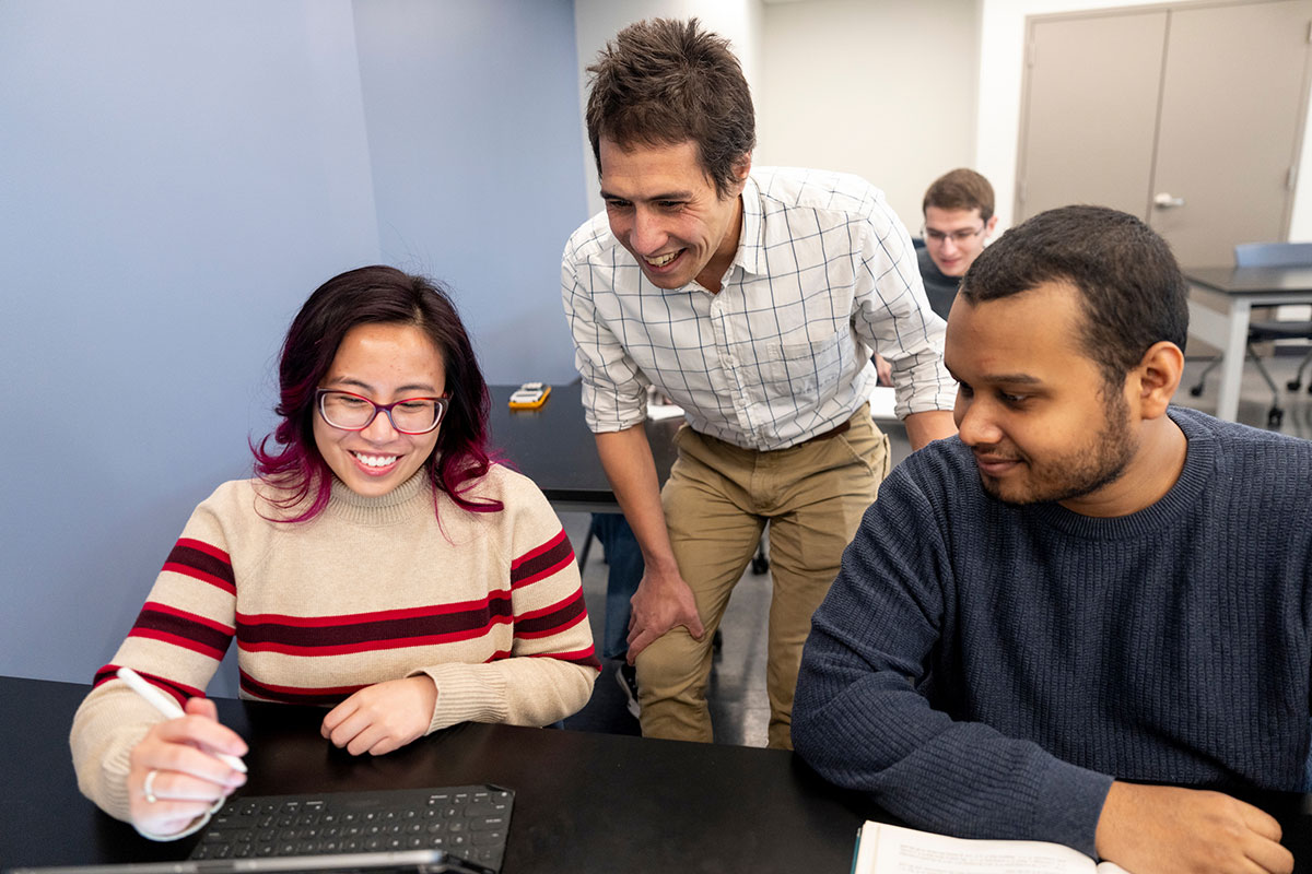 Professor assisting two students