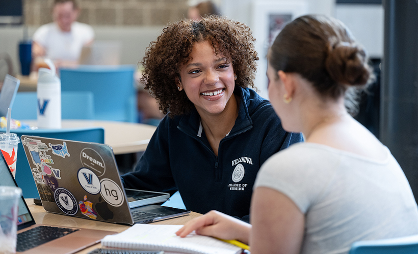 Students talking and studying in the Connelly Center.