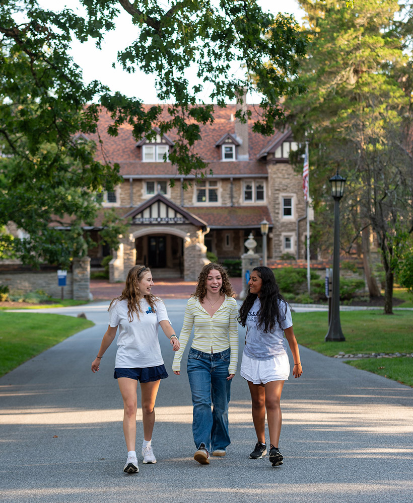Students walking and talking outside of Montefalco Hall.