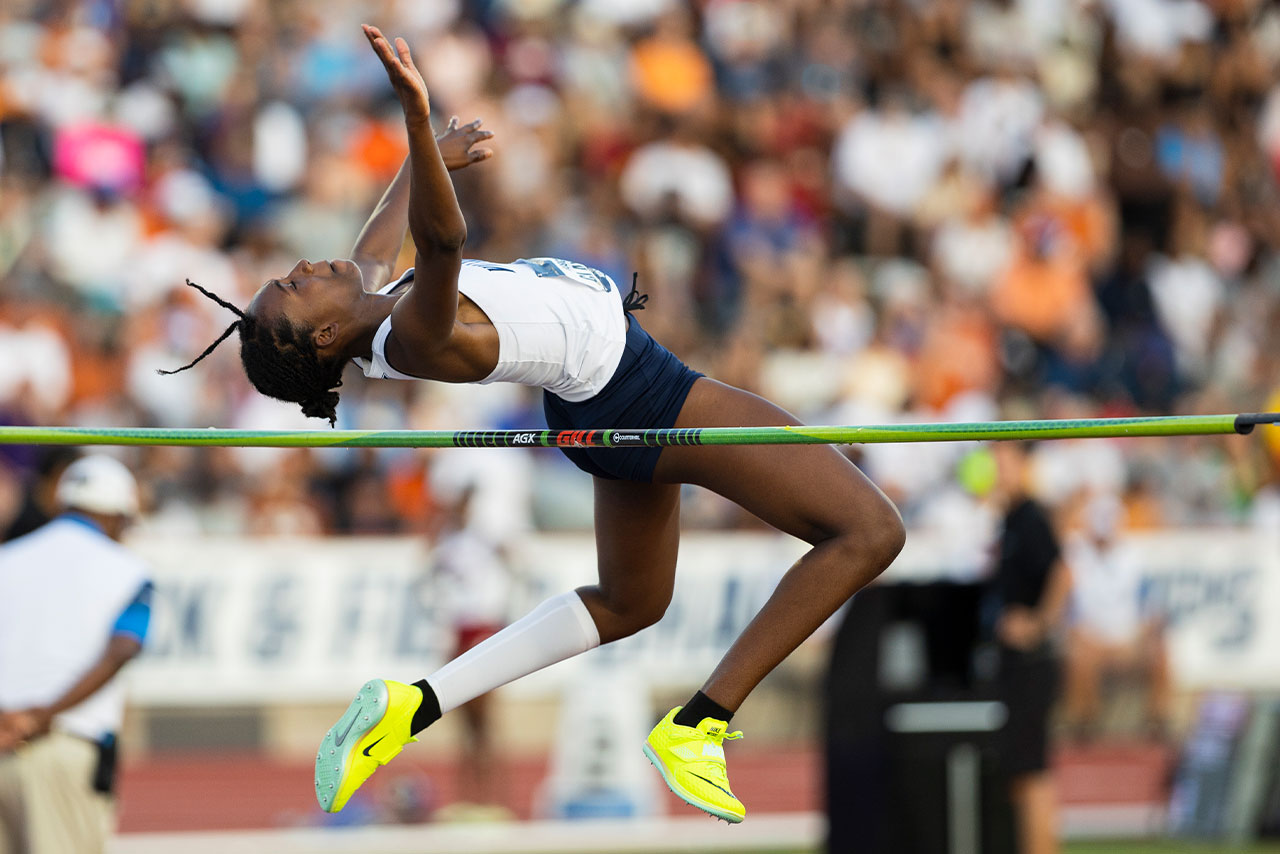 Women's Track & Field Athlete Roschell Clayton mid-jump