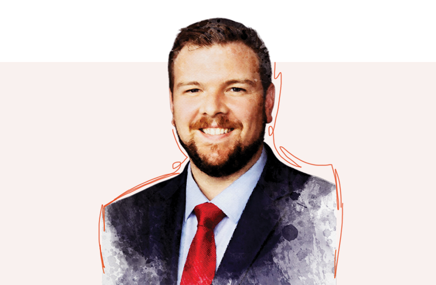 Headshot of Robert Duffy smiling directly at the camera wearing a dark blue suit with light blue shirt and red tie. 