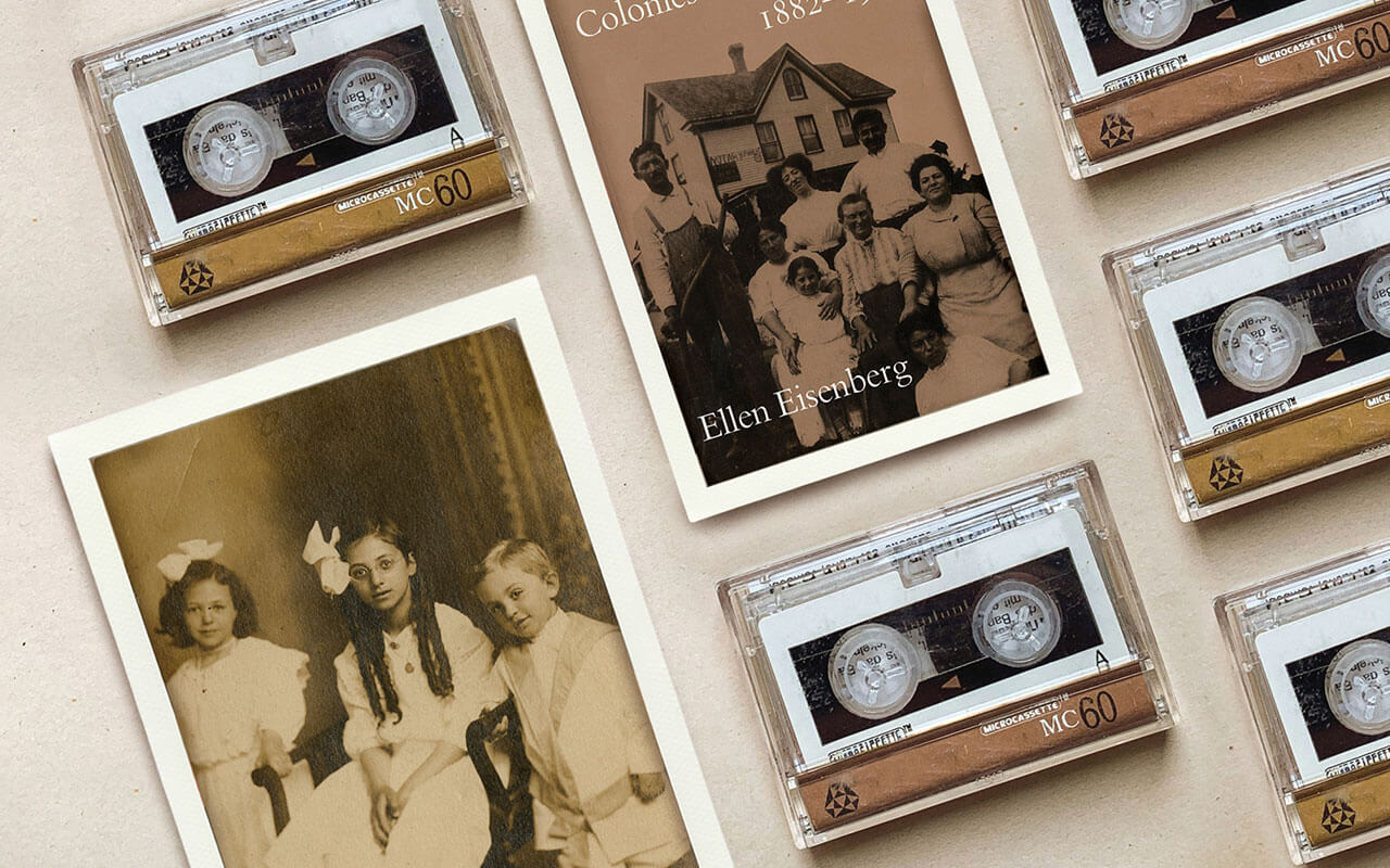 Sepia-toned image featuring a collection of cassette tapes, an old photograph of three children, and a partially visible book titled Jewish Agricultural Colonies in New Jersey 1882–1920 by Ellen Eisenberg.