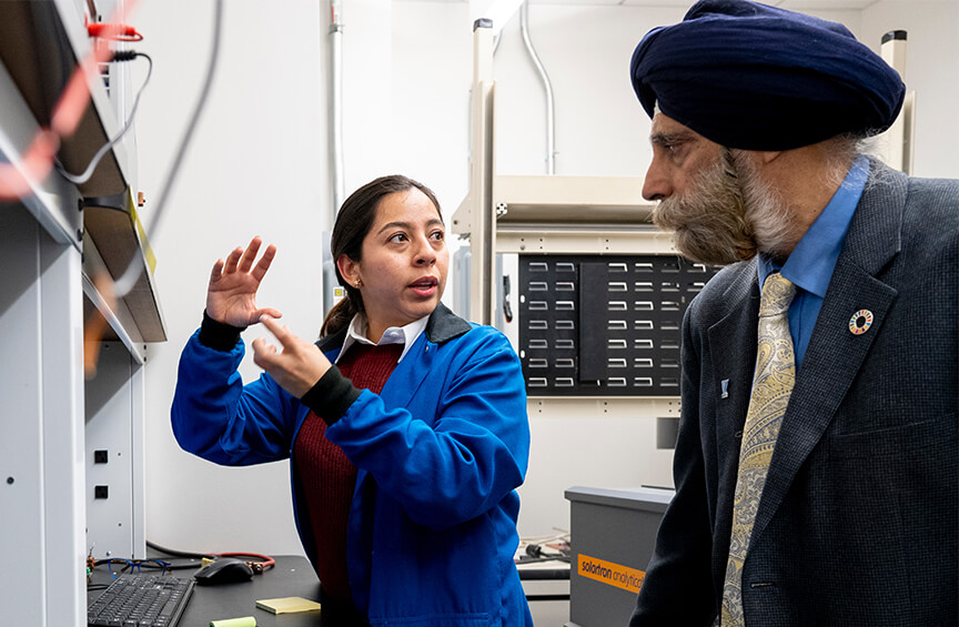 Professor Pritpal Singh, PhD, consults with Viviana Villavicencio Vallejo in the Conti Sustainable Energy and Materials Research Laboratory.
