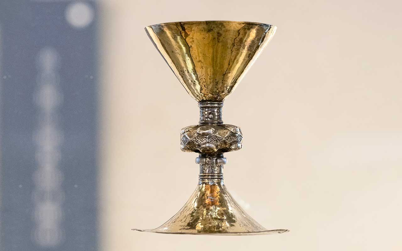 The Ó Learghusa Chalice, an ornate metal chalice photographed against a neutral background.
