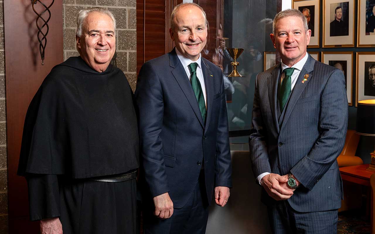 University President the Rev. Peter M. Donohue, OSA, PhD, ’75 CLAS, and US Ambassador to Ireland Edward Walsh ’86 COE stand with Taoiseach Micheál Martin in front of the historic Ó Learghusa Chalice.